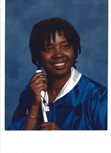 a woman in a graduation cap and gown holds a diploma