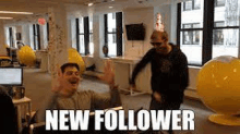 two men are dancing in a room with the words `` new follower '' written on it .