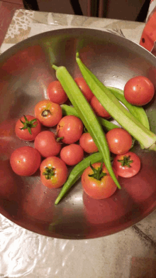 a bowl filled with tomatoes and green okra