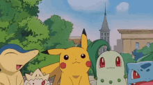 a group of pokemon are posing for a picture with a church in the background