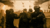 a group of soldiers are holding a man in a field
