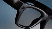 a close up of a pair of glasses with a button on it