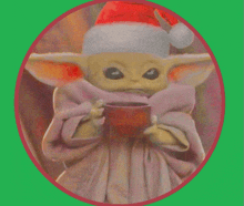 a baby yoda wearing a santa hat and holding a cup of coffee