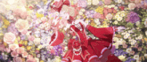 a girl in a red dress and hat is laying in a field of flowers