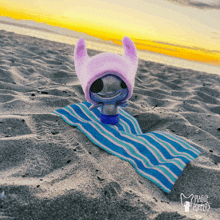 a plague puppies toy laying on a beach towel