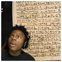 a man wearing headphones stands in front of a wall that has a lot of writing on it