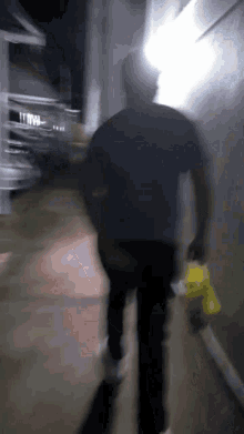 a blurry picture of a person walking down a hallway at night