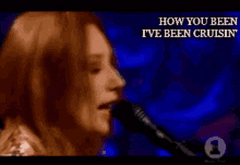 a woman singing into a microphone with the words " how you been i 've been cruisin " behind her