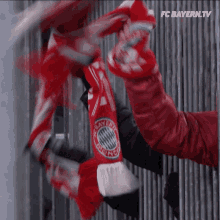 a person is holding a scarf with bayern munich on it