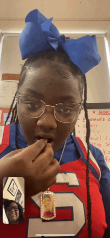 a cheerleader wearing a number 5 jersey talks to a woman on a video call