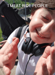 a boy wearing headphones is smiling with the words " i meat ride people " above him