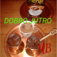 two cups of coffee on a copper tray with a bag of merak coffee in the background