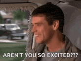a man is smiling while sitting in the back seat of a car and says `` aren 't you so excited ? ''