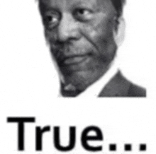 a black and white photo of a man in a suit and tie with the word true below him