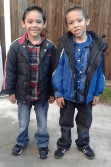 two boys standing next to each other with one wearing a jacket that says w.o.