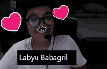 a boy with glasses and a mustache is wearing a microphone and the name labyu babagail is on the bottom right