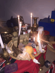 a bunch of candles are lit on a table with a bottle of coca cola on it