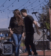 a man and a woman are dancing on a stage in front of a sign that says ncl