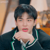 a young man in a suit and tie is making a funny face