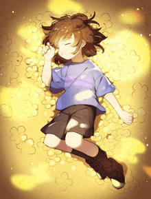 a boy in a blue shirt is laying on a pile of gold