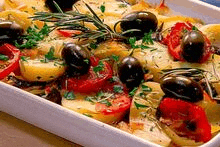 a white casserole dish filled with potatoes , tomatoes , olives , parsley and rosemary .