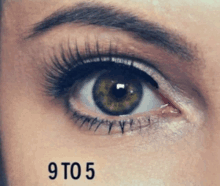 a close up of a woman 's eye with the number 9 to 5 written below it