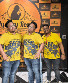 three men are posing for a picture in front of a wall that says mystery rooms