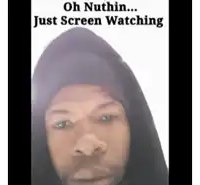 a man wearing a black hoodie with the words oh nuthin just screen watching