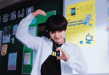 a man making a heart with his hands in front of a sign that says creative team coding challenge