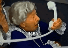 an elderly woman is talking on a telephone with the words `` i mean '' written above her .