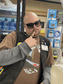 a man wearing sunglasses and a name tag that says ' katie ' on it