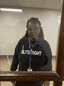 a woman wearing a black shirt that says elite sight on it