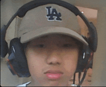 a boy wearing a la hat and headphones