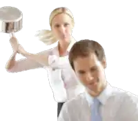 a woman in a pink shirt is holding a pot over a man 's head