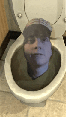 a man 's head is visible in a toilet