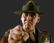 a man in a military uniform is pointing his finger