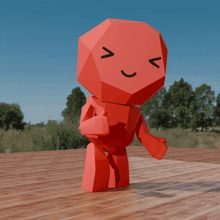 a red toy with a smiley face and a thumbs up