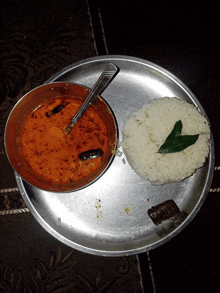 a plate of food with a bowl of soup and rice on it