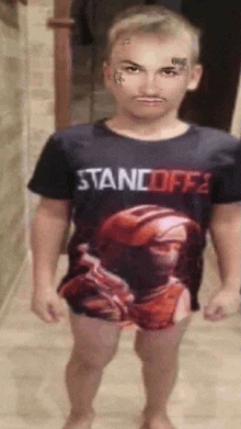 a boy wearing a shirt that says standoff 2 on it