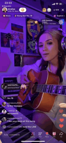 a woman singing and playing a guitar on a live stream