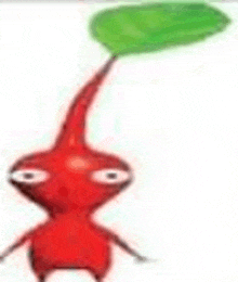 a red cartoon character with a long tail and a green leaf on its head .