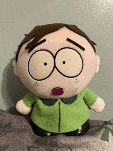 a stuffed south park character with a pink tongue