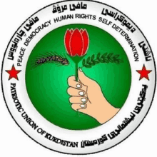 the logo for the patriotic union of kurdistan shows a hand holding a red rose .