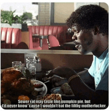 a man is sitting at a table with a plate of food in front of him