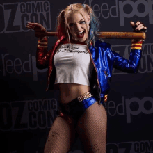 a woman in a harley quinn costume is holding a baseball bat