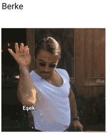 a man wearing sunglasses and a white shirt throws salt in the air with the caption berke