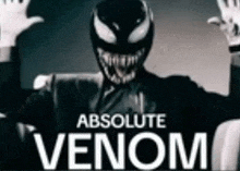 a man in a suit and white gloves is wearing a venom mask and gloves .