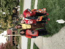 a group of children are posing for a picture with one wearing a shirt with the number 23