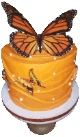 a yellow cake with butterflies on top of it