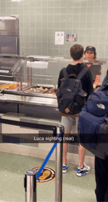 a boy with a backpack is standing in front of a counter with a sign that says luca sighting real